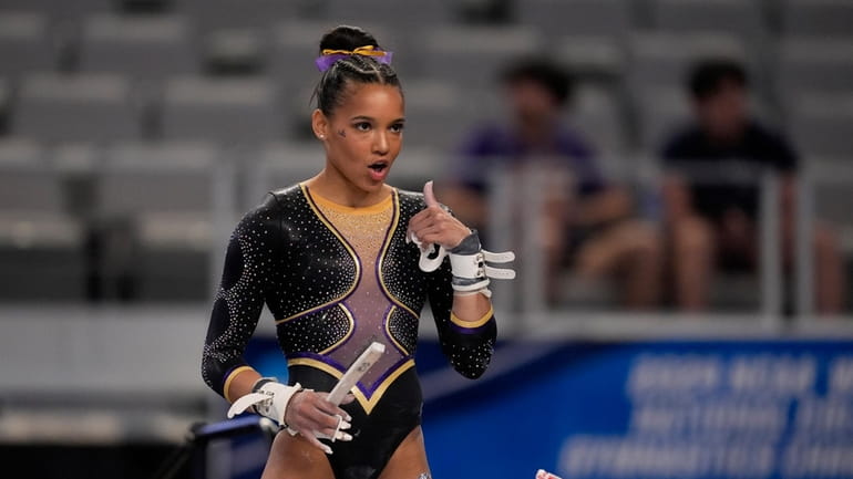 LSU's Haleigh Bryant gestures to teammates standing nearby as she...
