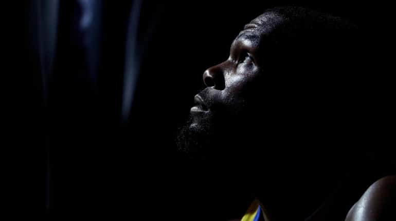 Golden State Warriors' Kevin Durant looks up as the team...