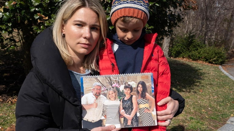 Jenya Semenkova, with her son Robert Schwartz, 6, holds a...