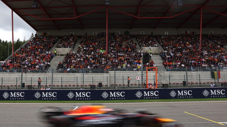Fans watch from the stands as Red Bull driver Max...