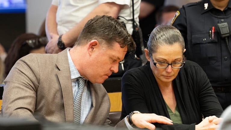 Angela Pollina, right, listens to her attorney, Matthew Tuohy, before...