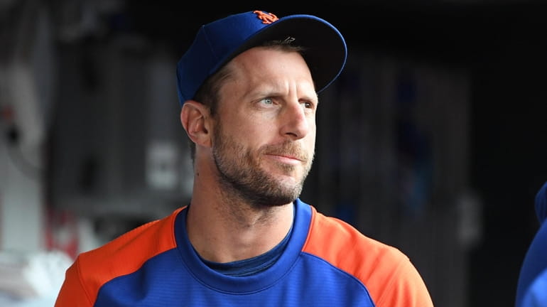 Mets pitcher Max Scherzer looks on from the dugout during...