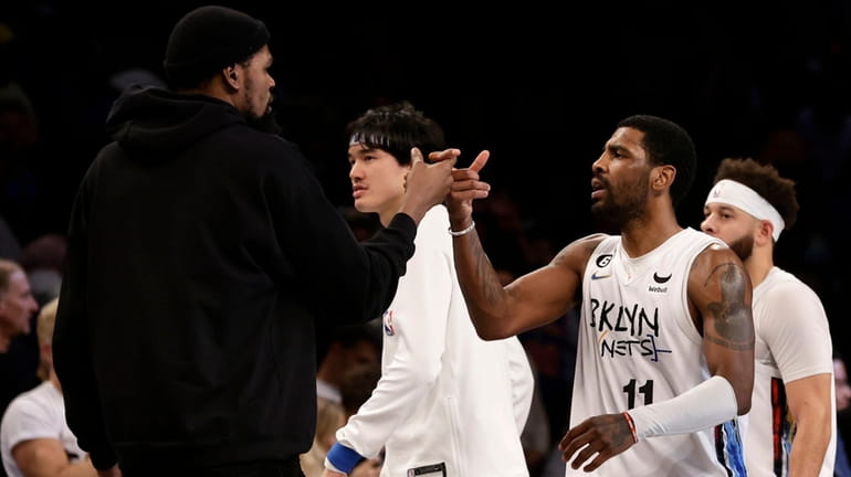 Kyrie Irving of the Nets reacts after a basket in...