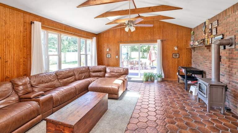 The family room has beamed ceilings and a gas stove.