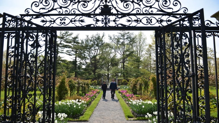 Visitors stroll through the walled garden, home to a variety...