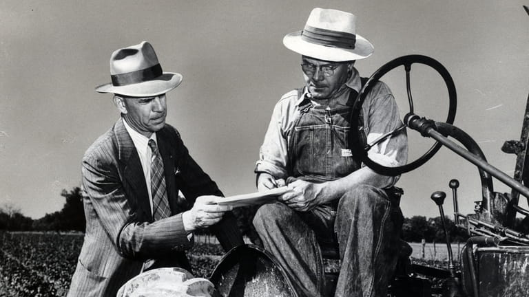 A census worker assists a farmer in 1950.