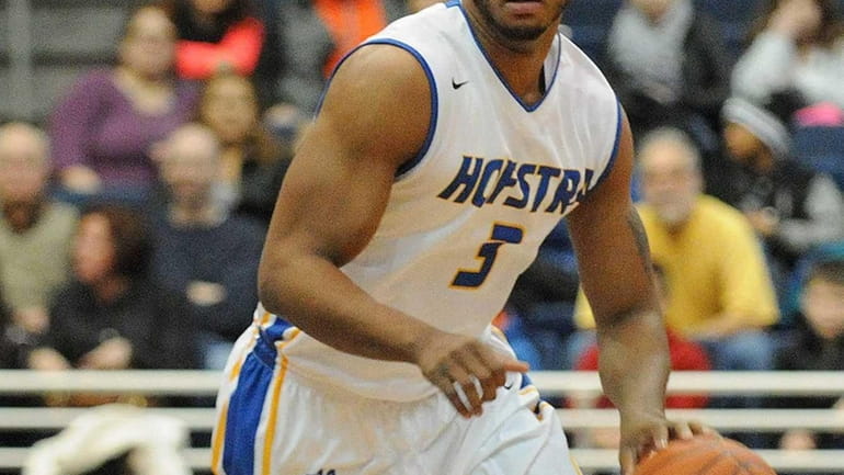 Hofstra guard Zeke Upshaw dribbles upcourt against Manhattan during the...
