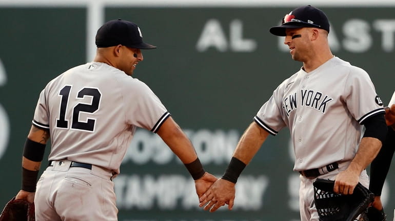 Rougned Odor and Brett Gardner congratulate each other after the...