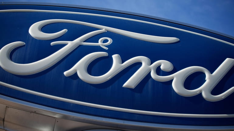 The Ford company logo is seen, Oct. 24, 2021, on...