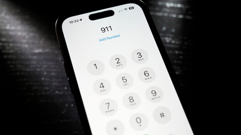 Emergency 911 number is dialed on a mobile phone, Thursday,...