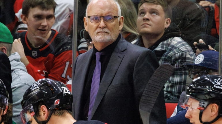 New Jersey Devils head coach Lindy Ruff, center, looks toward...