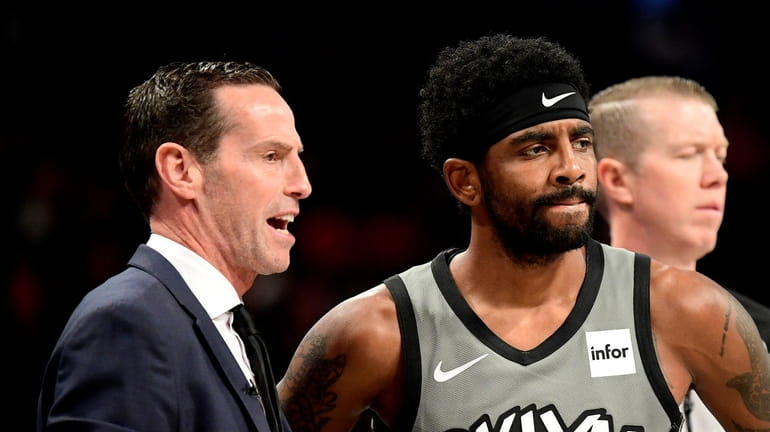 Nets head coach Kenny Atkinson speaks with Kyrie Irving at Barclays...