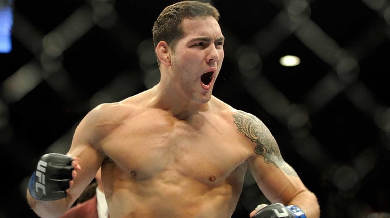 Chris Weidman reacts after knocking down Anderson Silva during the...