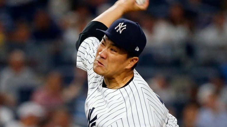 Yankees pitcher Masahiro Tanaka delivers against the Baltimore Orioles at...