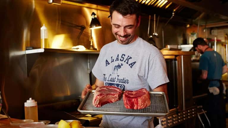 Chef-owner Alexis Trolf readies two dry-aged ribeye steaks at Lost...