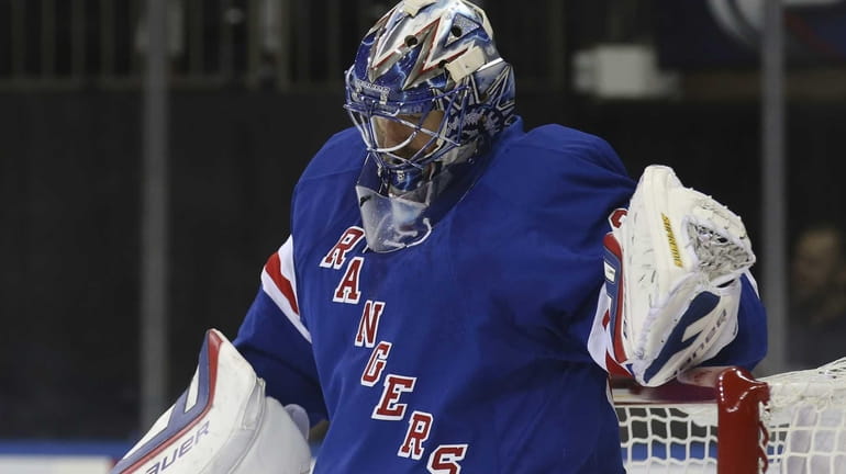 Rangers goalie Henrik Lundqvist (30) reacts after giving up two...