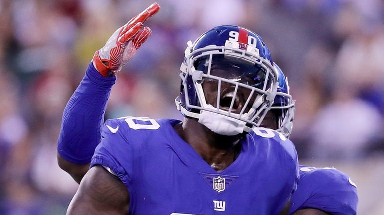 Jason Pierre-Paul of Giants is congratulated after a sack against...