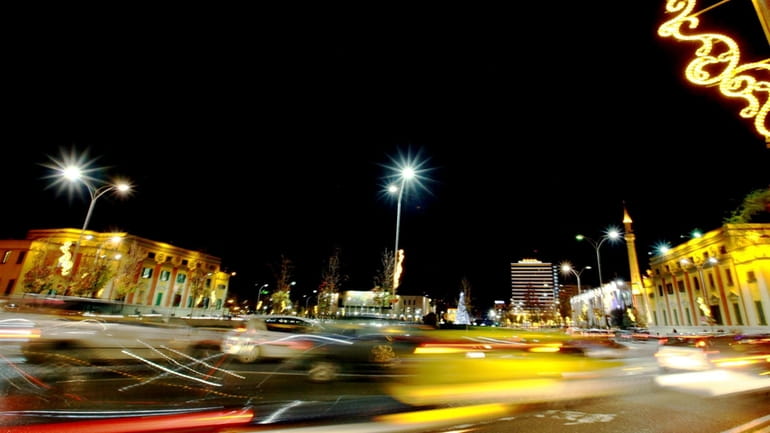 Traffic passes in Albania's capital main Skanderbeg Square in Tirana,...