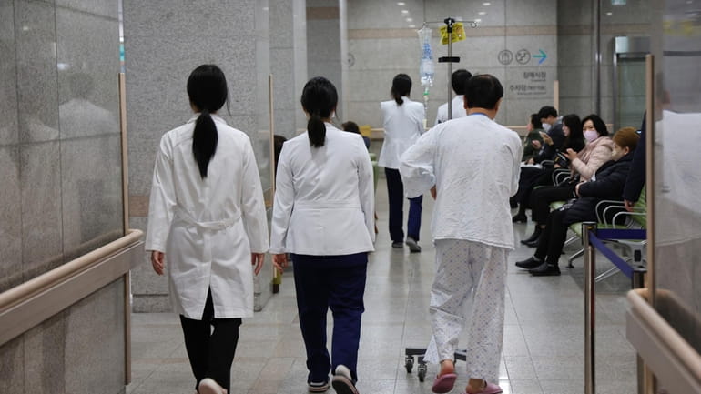 Medical workers walk inside a general hospital in Incheon, South...