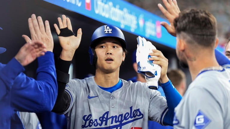 Los Angeles Dodgers designated hitter Shohei Ohtani (17) celebrates with...