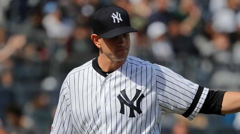 Yankees starting pitcher James Paxton motions to teammates after forcing...