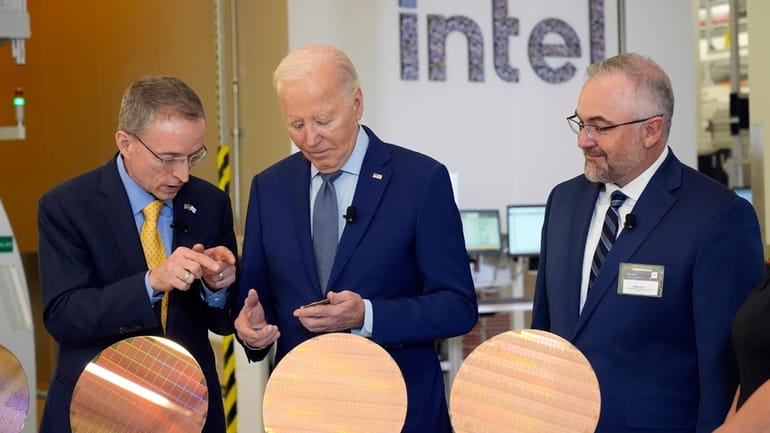 President Joe Biden listens to Intel CEO Pat Gelsinger, left,...