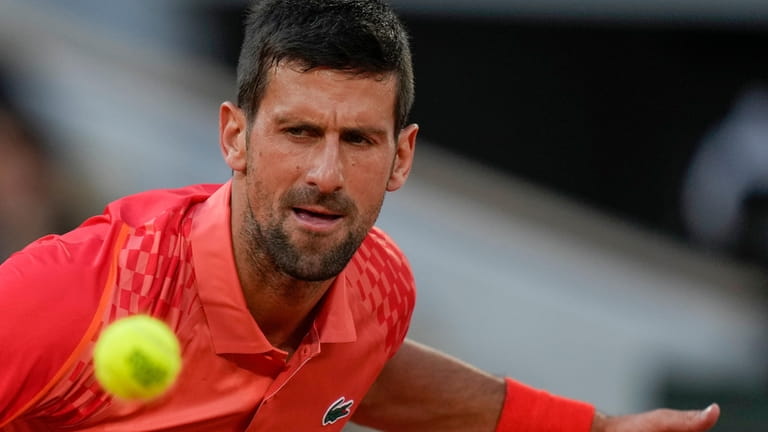 Serbia's Novak Djokovic eyes the ball as he plays a...