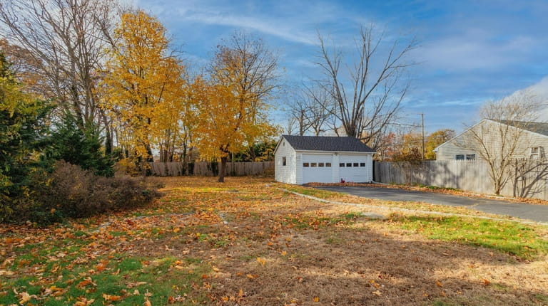 The two-car garage at the back of the fenced-in 0.3-acre property.