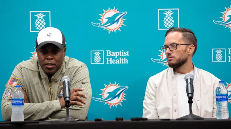 Miami Dolphins general manager Chris Grier , left, and head...