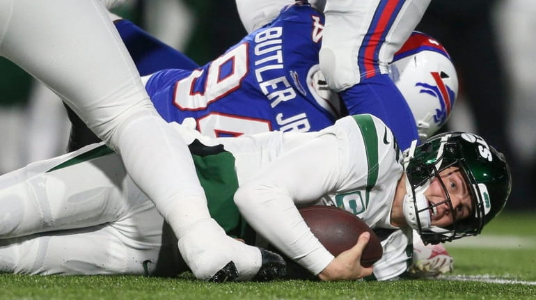 Jets quarterback Zach Wilson, bottom right, is sacked during the...