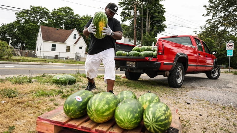 Shawn Haynes, owner of Strong Island Produce in Wyandanch, unloads...