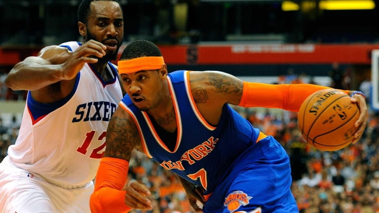 Carmelo Anthony of the Knicks drives to the basket past...