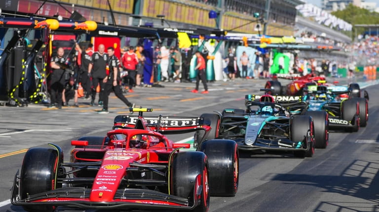 Ferrari driver Carlos Sainz of Spain steers his car down...