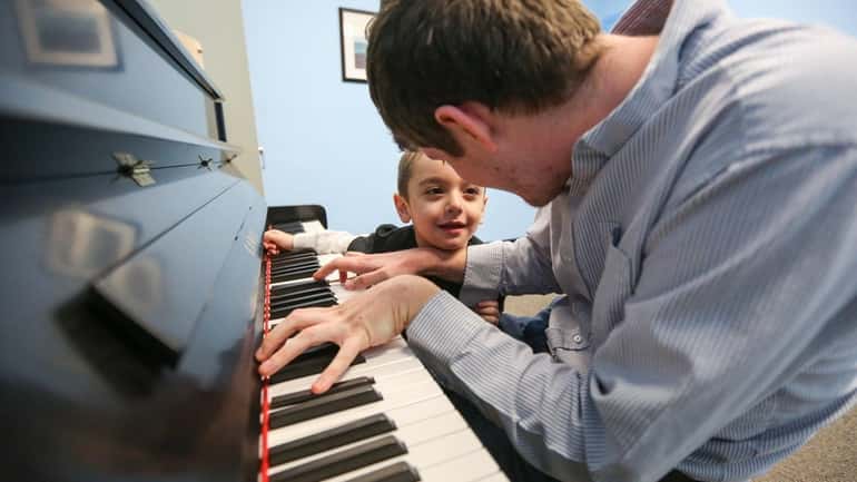 Jake Vassallo of Massapequa, 5, participates in a music therapy...