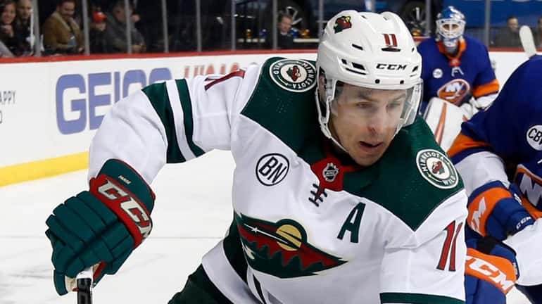 Zach Parise of the Wild controls the puck during the first...