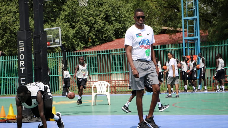 FILE - Masai Ujiri walks on the basketball court during...