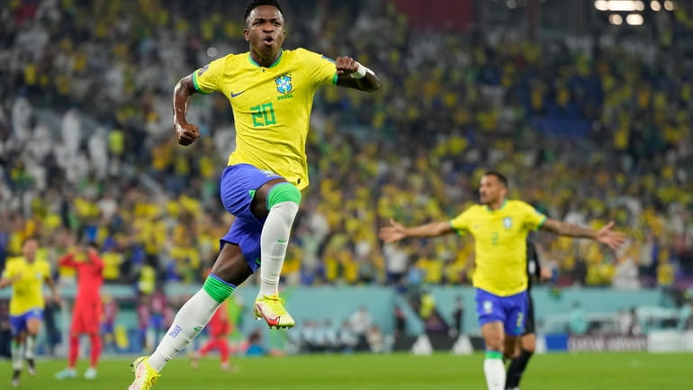 Brazil's Vinicius Junior celebrates after scoring his side's opening goal...