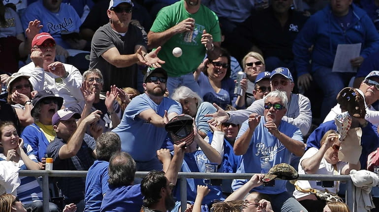Fans vie for a foul ball hit by New York...