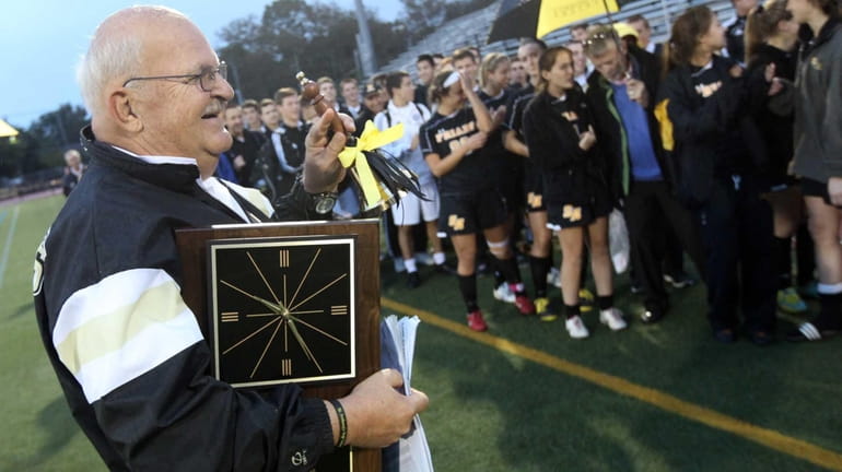 St. Anthony's Head Coach Dave Prutting is applauded by his...