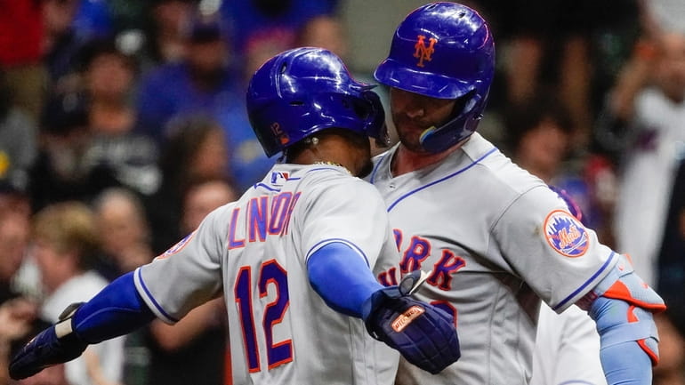 The Mets' Pete Alonso is congratulated by Francisco Lindor after...