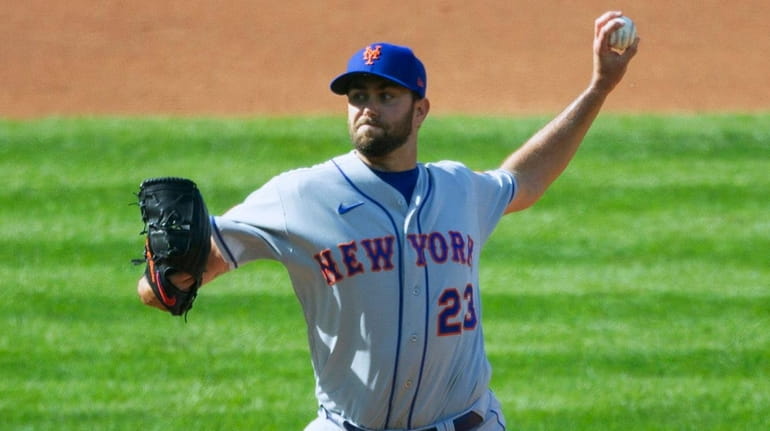 Mets starting pitcher David Peterson (23) throws during the first...