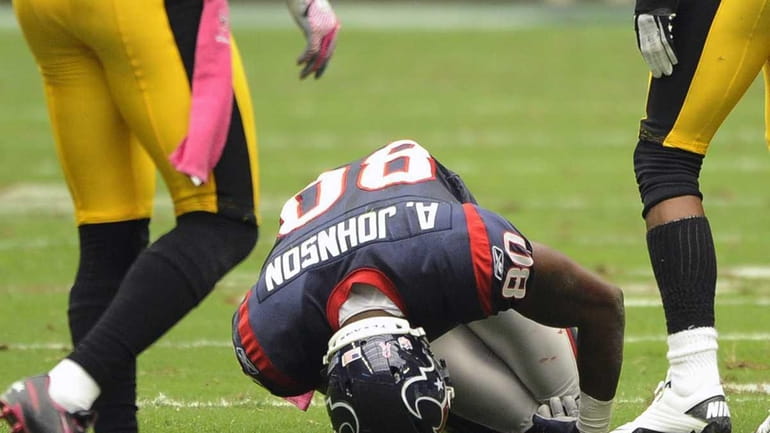 Houston Texans wide receiver Andre Johnson falls to his knees...