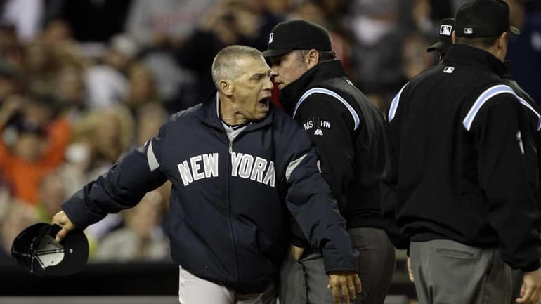 Yankees manager Joe Girardi, left, goes around umpire Jerry Layne...