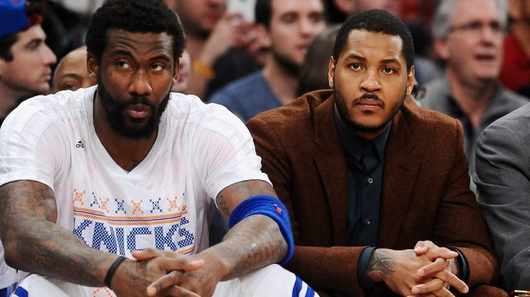 Amar'e Stoudemire and Carmelo Anthony sit on the sidelines during...