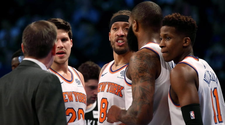 Knicks coach Jeff Hornacek speaks with his team during a...