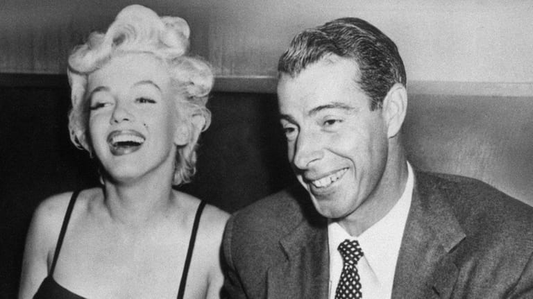 Marilyn Monroe, left, laughs with her husband, Joe DiMaggio, at...