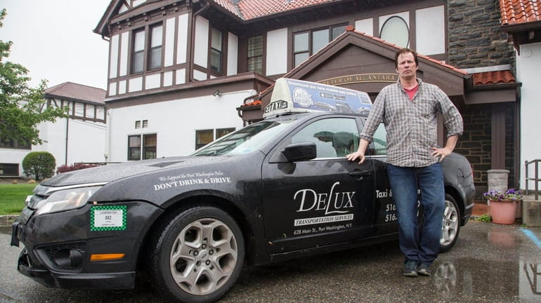 Danny Doherty, a driver for Delux Transportation Services, with his...