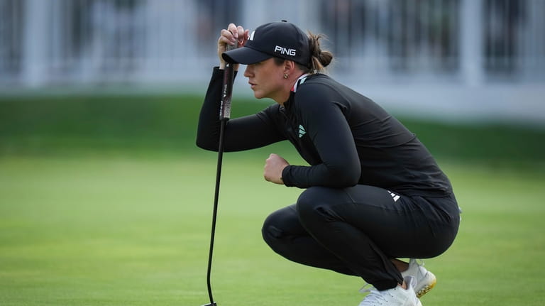 Linn Grant, of Sweden, lines up a putt on the...