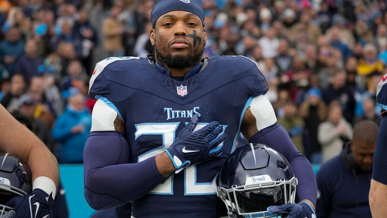 FILE -Tennessee Titans running back Derrick Henry stands for the...
