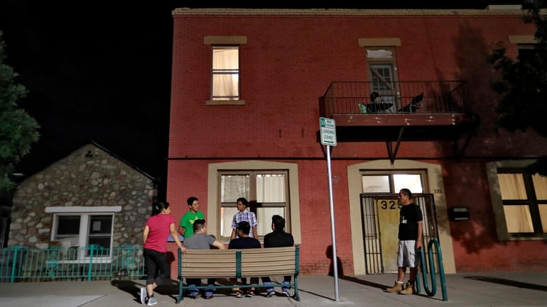 Migrant parents outside the Annunciation House, in El Paso, Texas....